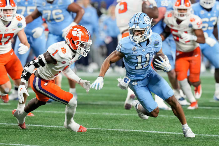 Dec 3, 2022; Charlotte, North Carolina, USA; North Carolina Tar Heels wide receiver Josh Downs (11) and Clemson Tigers safety Andrew Mukuba (1) at Bank of America Stadium. Mandatory Credit: Jim Dedmon-USA TODAY Sports